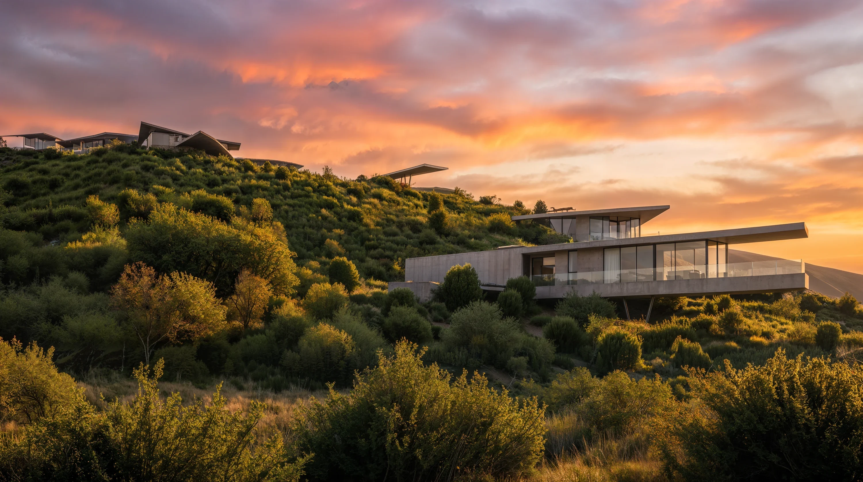 A cantilevered Mira Verde villa on the ridge under a burning sunset sky
